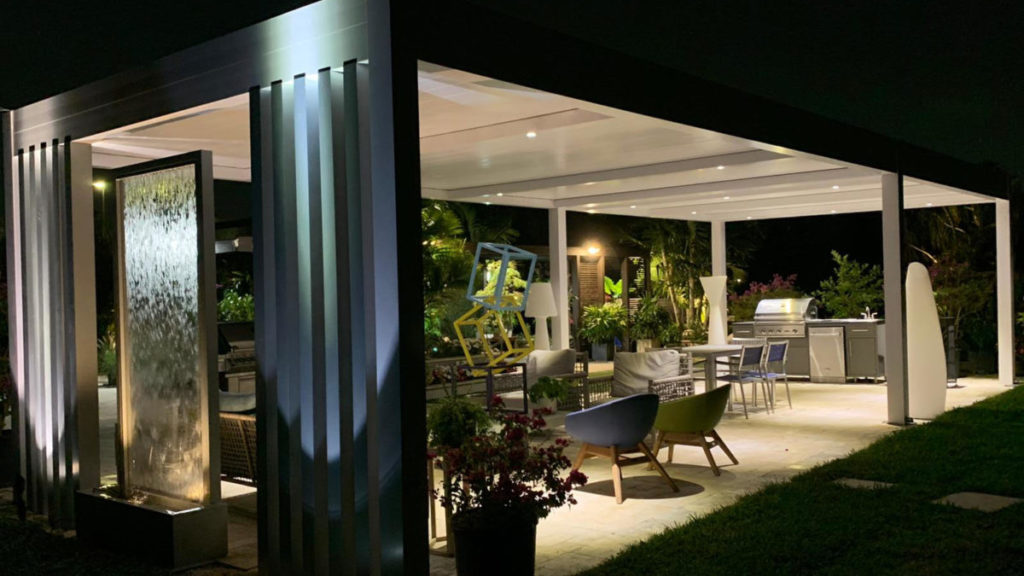 modern outdoor living area with illuminated pergola and water feature by bb-builders pro