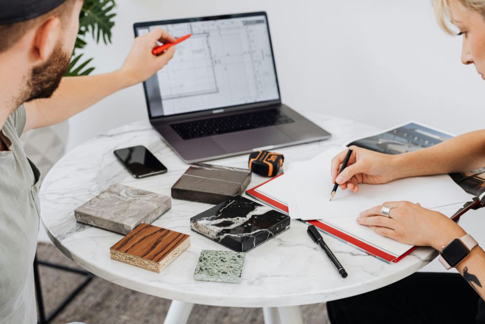 client and designer collaborating with the help of computer assisted design, which includes bathroom 3d models