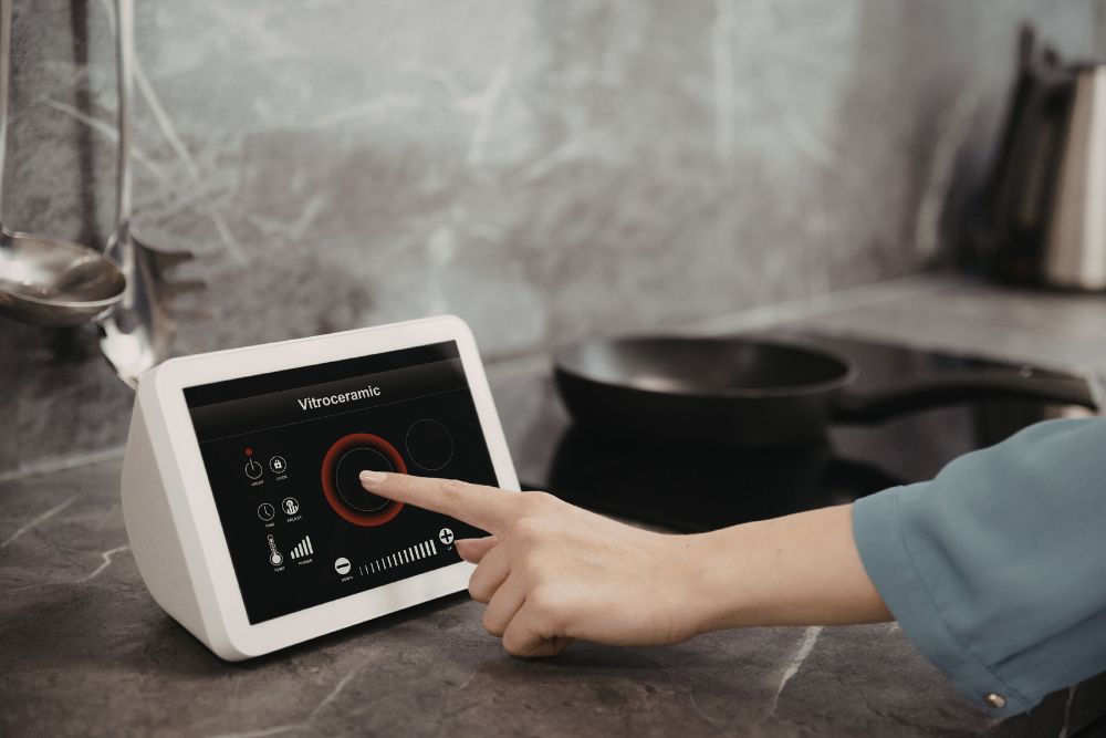 a person accessing a smart kitchen app called vitroceramic via a touchscreen device
