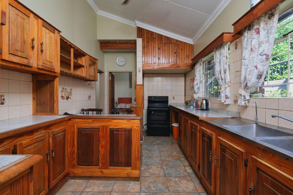 classic kitchen design featuring stained wood and stone tiles