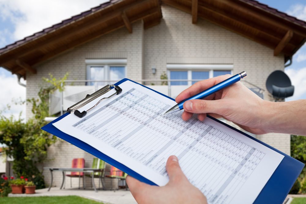 person holding a checklist assessing a home's value