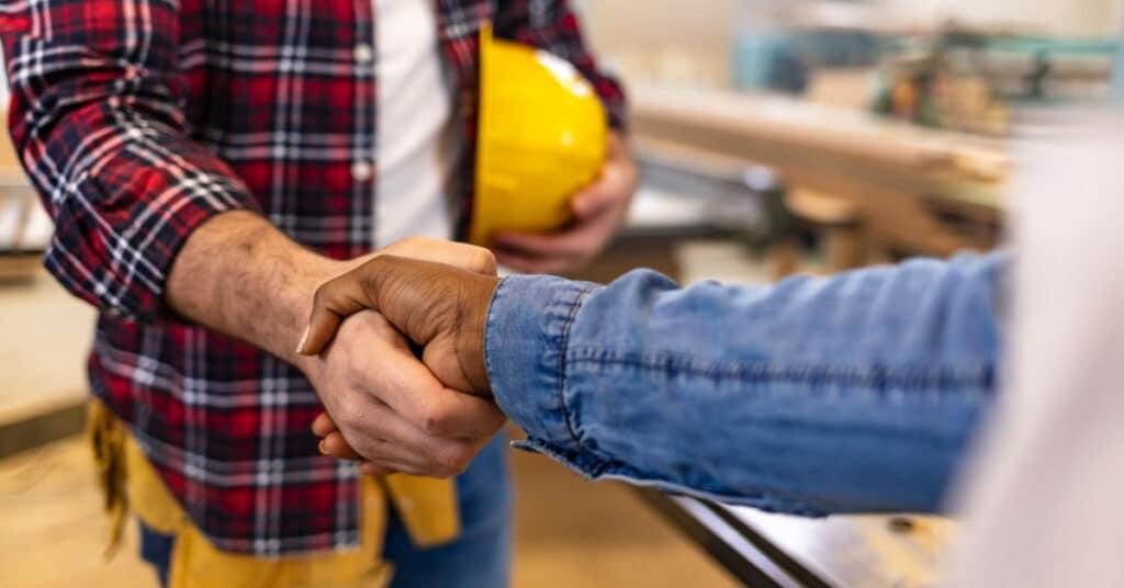 shaking hands with a bathroom remodel contractor
