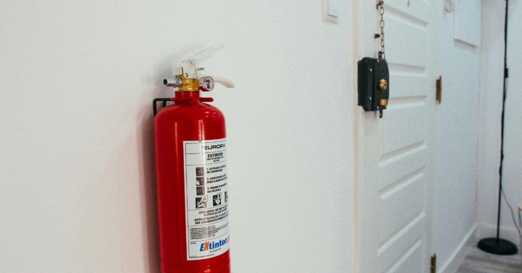 fire extinguisher hanging on a kitchen wall