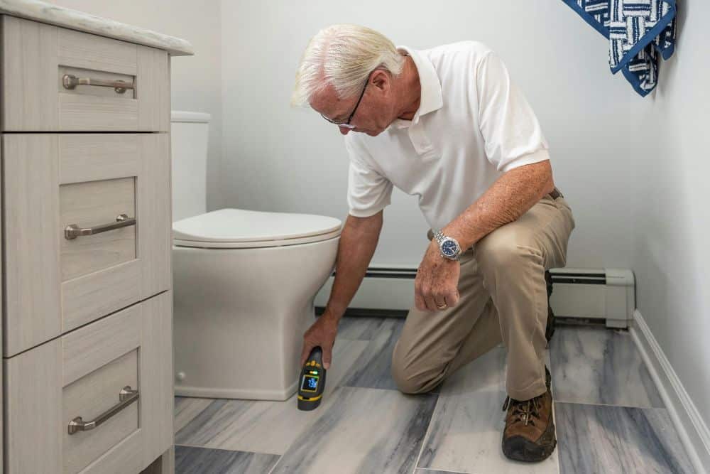 man checking his bathroom floor as part of the freestanding tub pre-installation stage