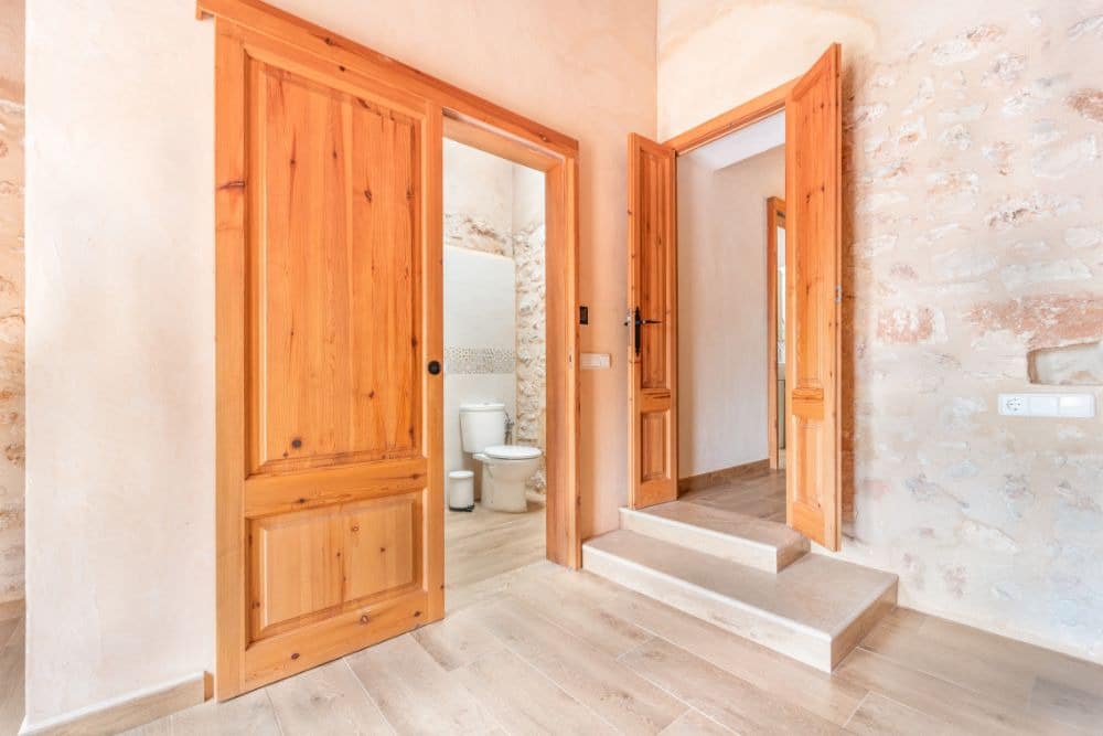 wooden sliding bathroom doors opening to the toilet