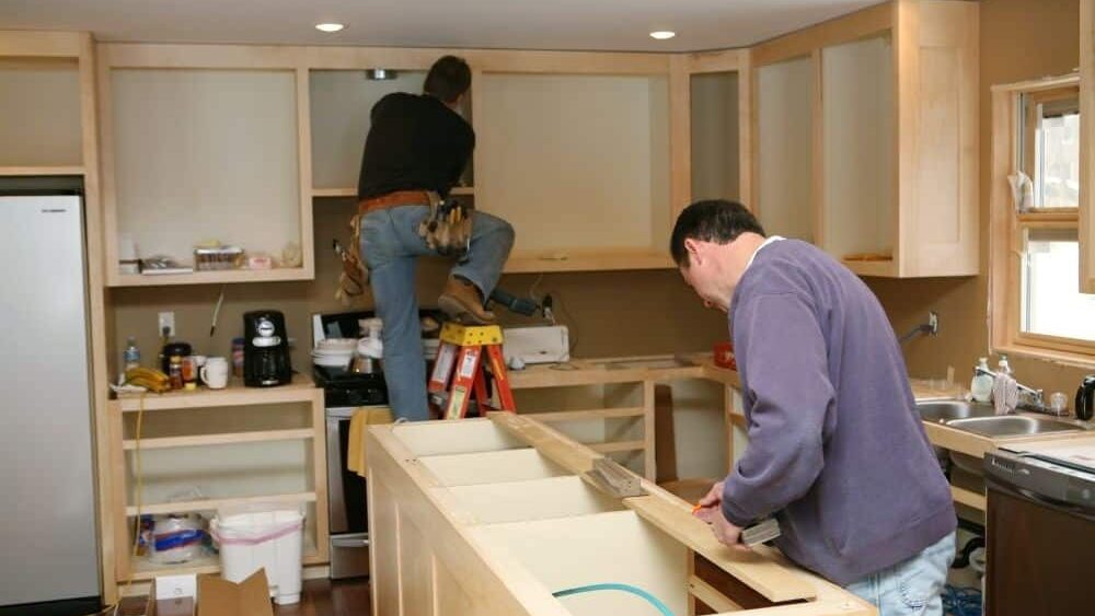 two men working on a kitchen remodel