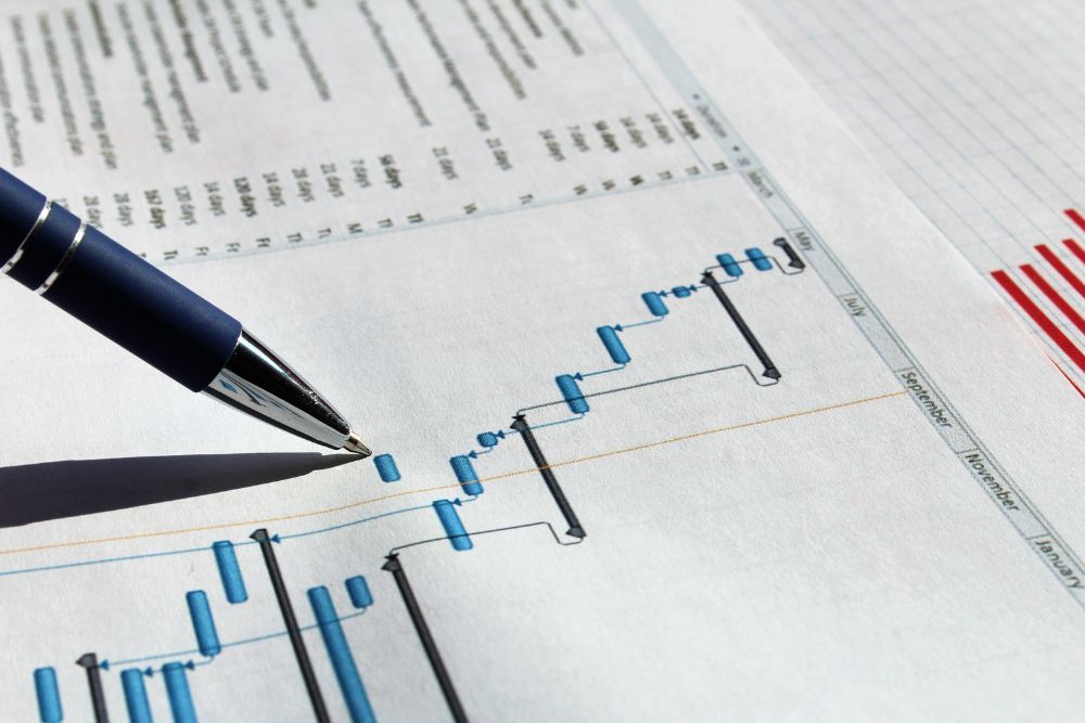 pen tracing a printed project timeline