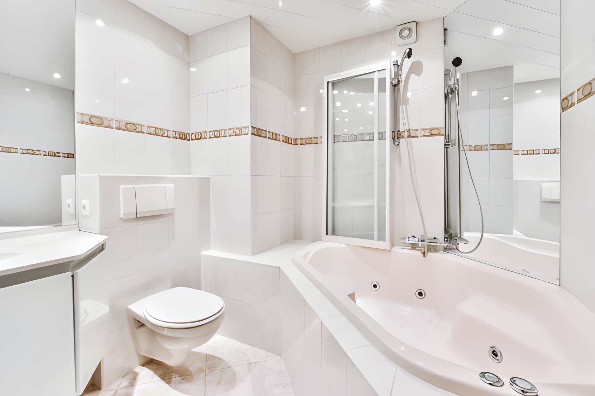 large wet bath with a bathtub and mirrors