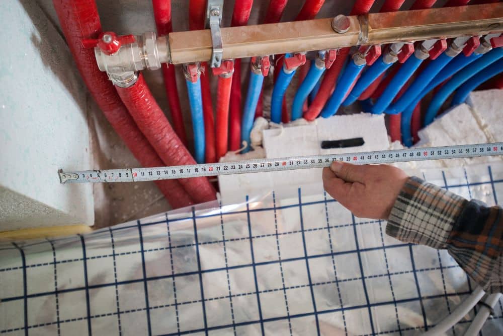 Complex bathroom floor heating installation demonstrating the typical radiant heated bathroom floor cost