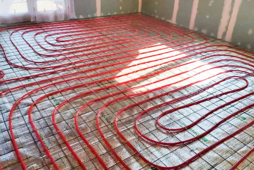 loose electric heating wires laid out and secured on the subfloor