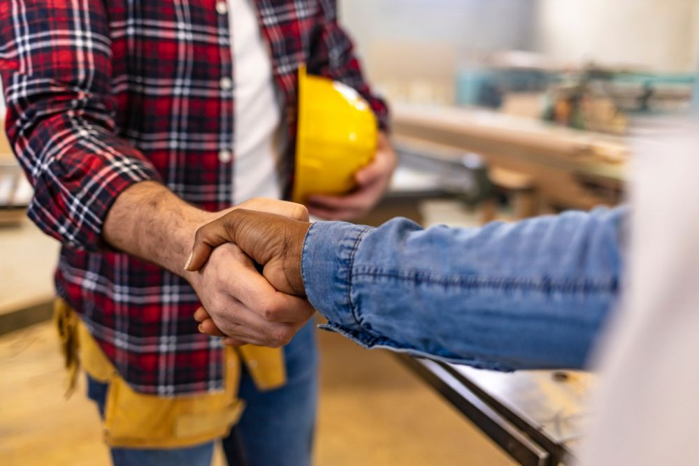 a bathroom remodel contractor shaking hands with a seattle homeowner