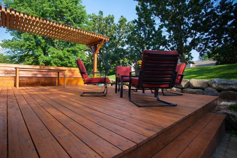 a low deck with red chairs, the height of which should trigger deck permit requirements seattle residents need to comply with.