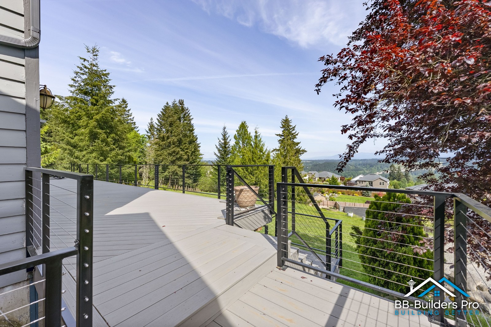 composite deck with metal cable railing and view seattle