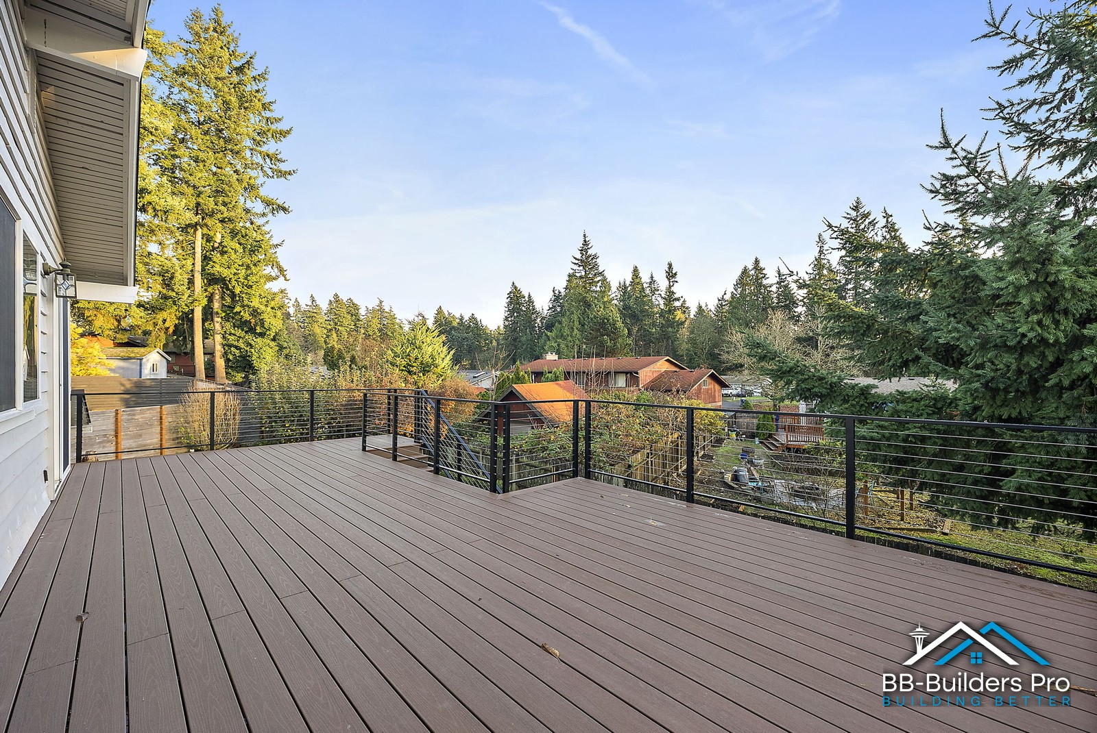 wide composite deck with cable railing and treed view in the seattle area