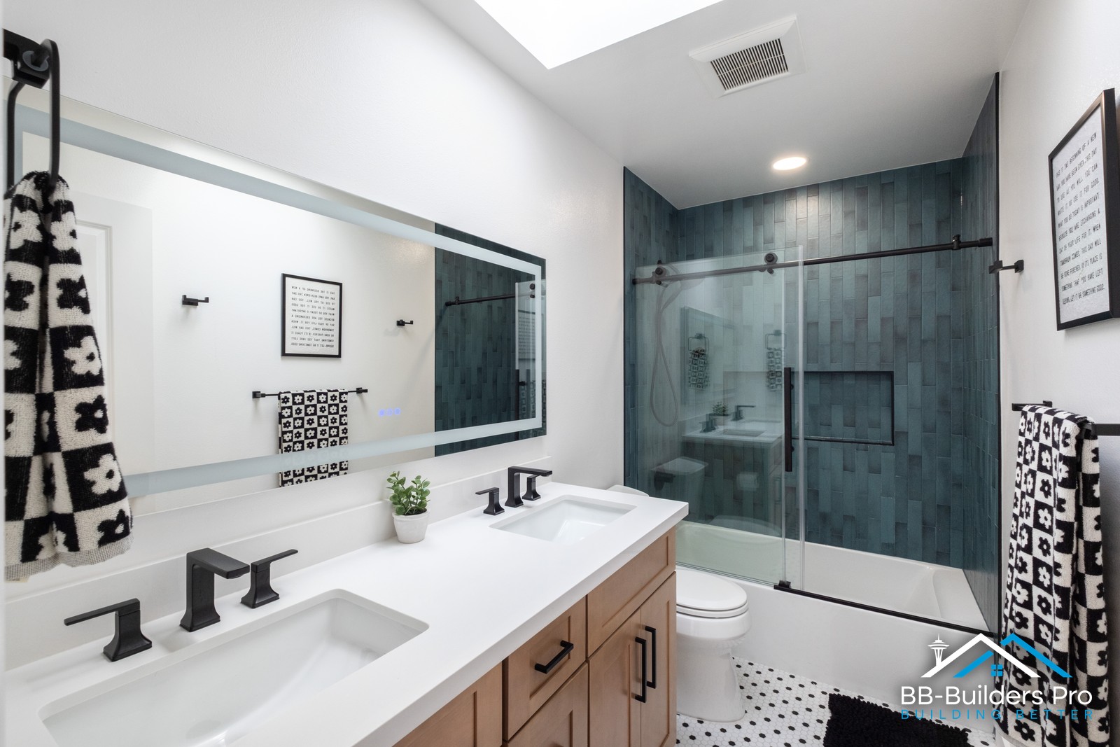 double vanity with wood cabinet and matte black faucets in a remodeled seattle bathroom by bb-builders pro