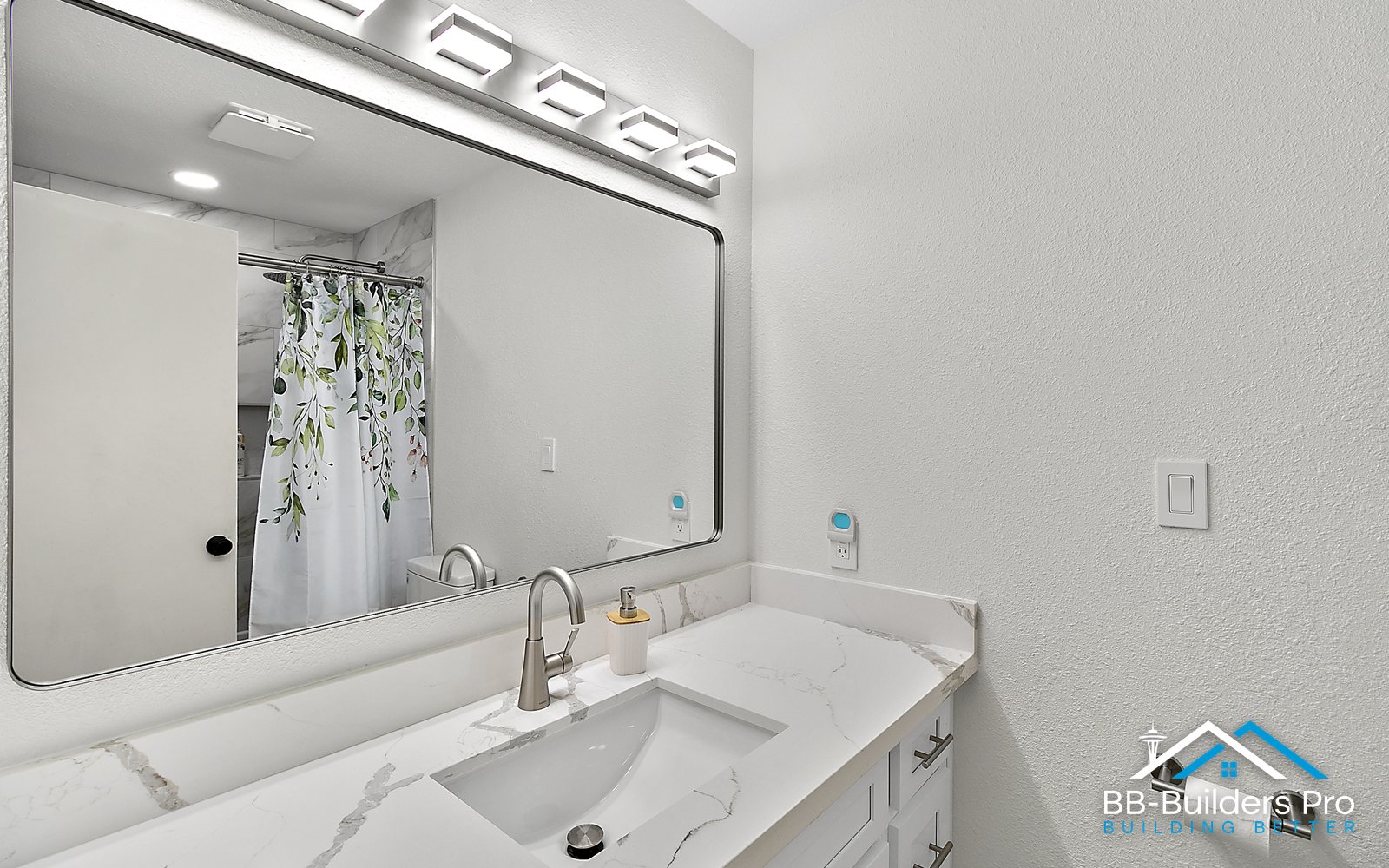 new vanity with quartz top and led mirror after a bathroom demolition and rebuild