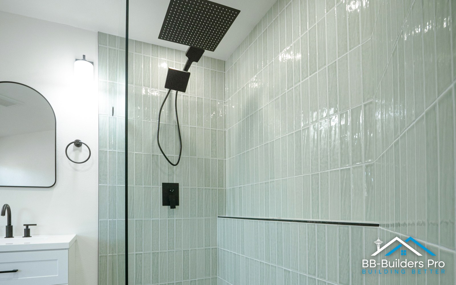 Full-height tiled walk-in shower with glass panel and black rain head