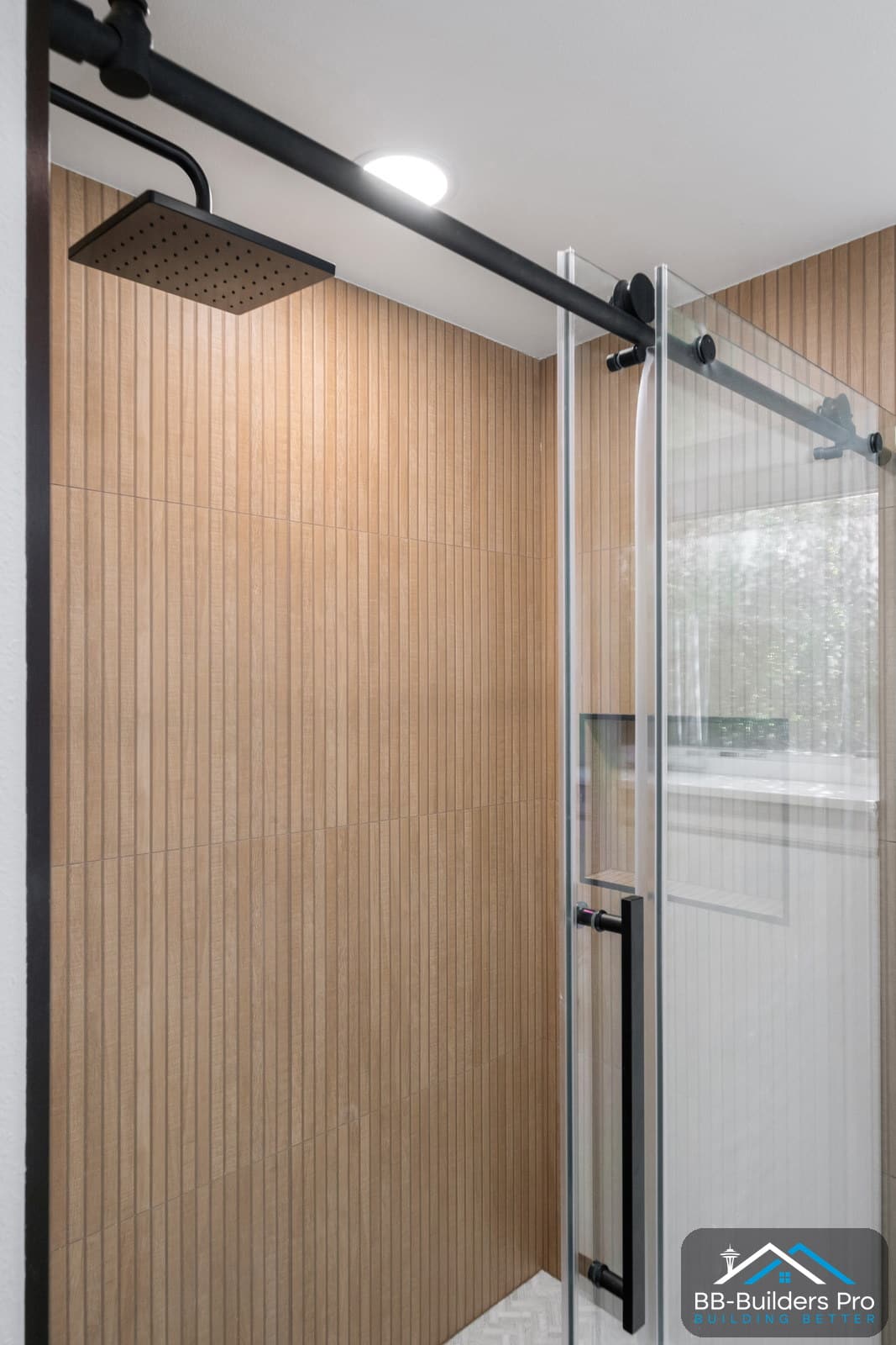 tiled walk-in shower with a wall-mounted shower valve and rain head in a seattle bathroom remodel